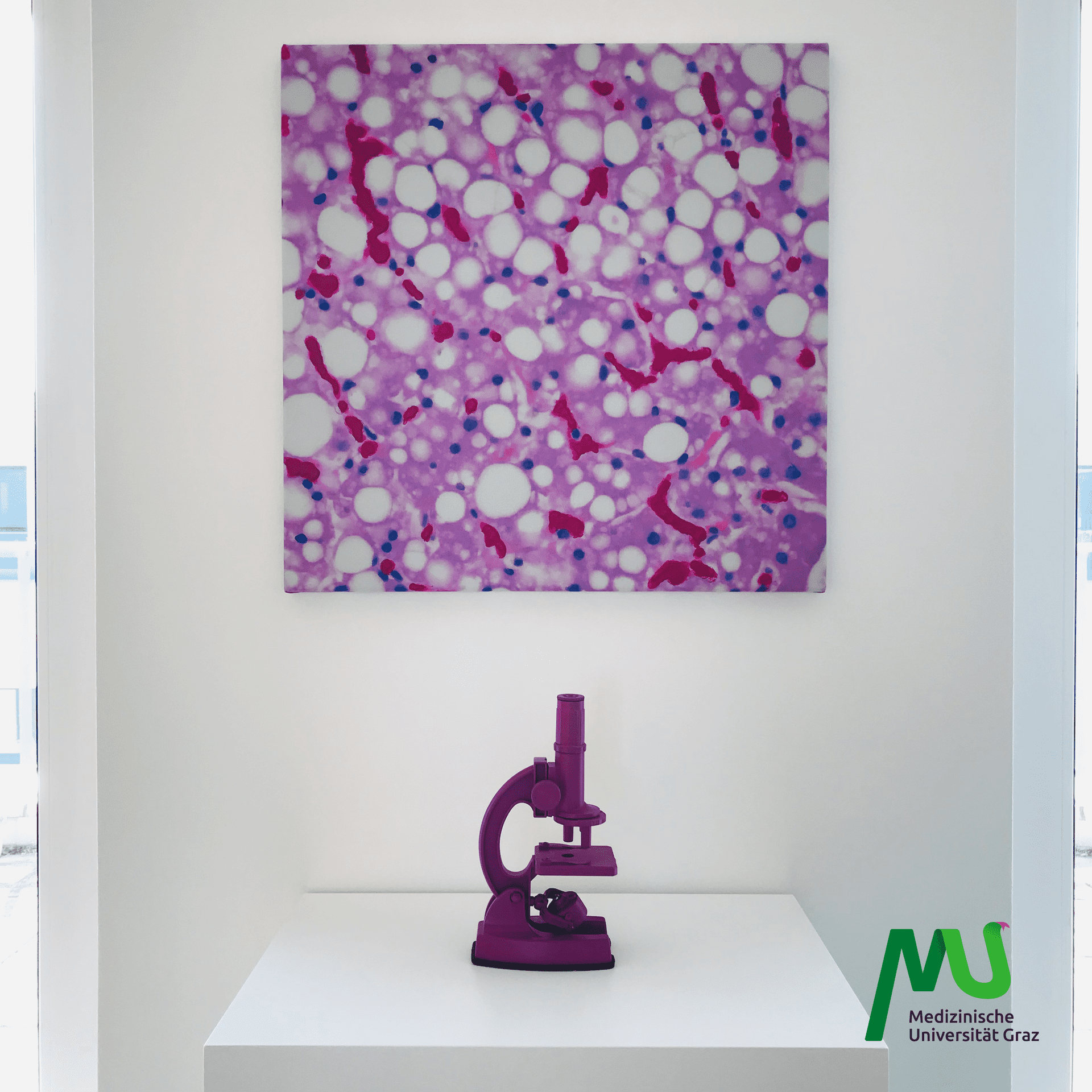 A purple microscope on a white surface, symbolizing the precision and innovation of CANCOM smART Walk.