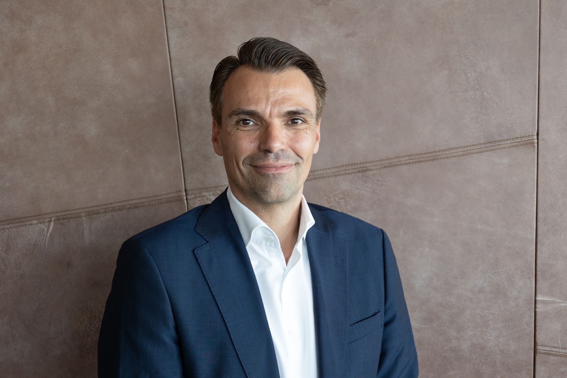 Jochen Borenich, CEO of CANCOM Austria AG, in a suit and tie, smiling.